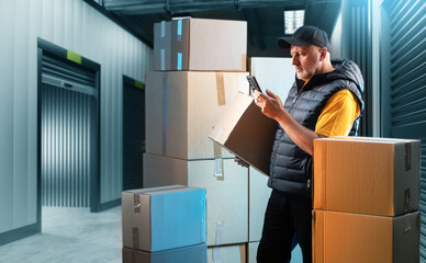 Business man near storage container. Warehouse for goods. Open storage container near guy. Man in...