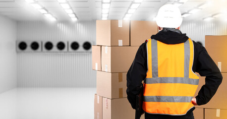 Man inside cold storage warehouse. Industrial freezer. Man brought boxes into empty cold storage...