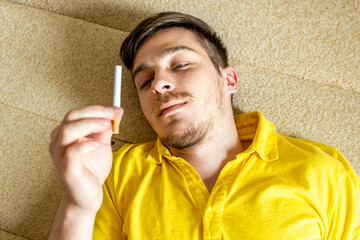 Pensive Young Man with a Cigarette - 746695817