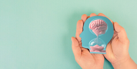 Human mind, mental health and psychology concept, dementia or Alzheimer disease, brain memory loss, lifetime running through hourglass
