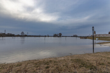 early spring flood, high water in the countryside, river overflowing its banks, trees in the water,...