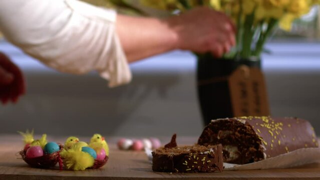 Celebrating Easter chocolate cake s and daffodil flowers display