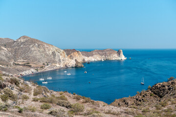 View with boats of the coast of Akrotiri and the black sand beach that is known locally as Mesa Pigadia beach. Greek Islands, Santorini, European Vacation