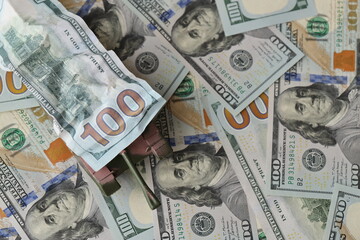 Tank on crumpled hundred dollar bills banknotes. Background of war funding and military support price for United States of America