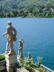 Beautiful view of the sculpture and lake on a summer day. Isola Bella. Italy.
