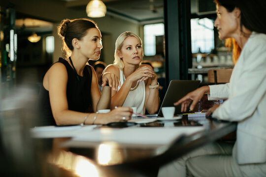 Businesswomen working together on a project in a cafe