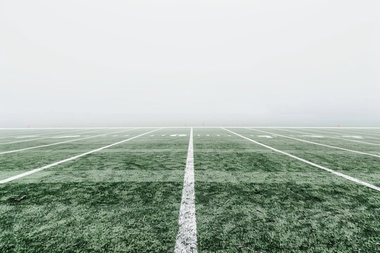 Close up of American football stadium field with yard line markings and white background for copy space