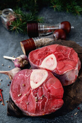 raw Ossobuco. Veal shanks Ossobuco with pepper, lemon and garlic for gremolata, typical ingredients...