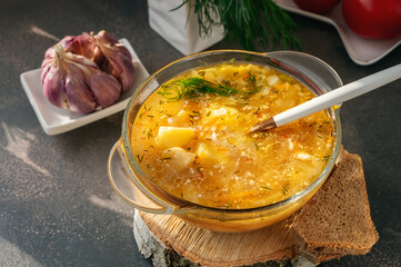 cabbage soup with sour cream. Homemade vegetable soup with sour cream on a wooden background, close-up. soup is served in a transparent tureen