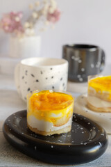 dessert made from yogurt and jelly. Layered orange peach and biscuit dessert in transparent film, layered yogurt dessert idea. Soft selective focus.