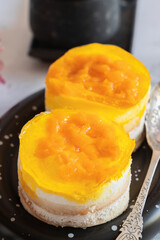dessert made from yogurt and jelly. Orange peach and sponge cake layered dessert idea, yogurt and fruit layered dessert idea. Soft selective focus.