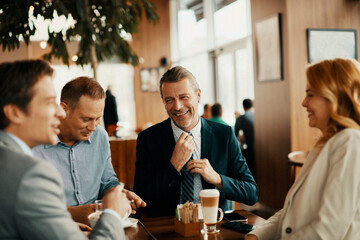 Business people having a meeting at an indoor cafe