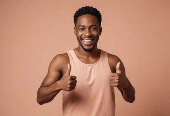 A joyful man in a sleeveless top gives double thumbs up, with a big smile conveying excitement and positivity.