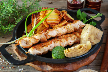 chicken kebab with artichoke, potatoes with herbs and spices. Close-up of a white meat chicken and turkey meat dish