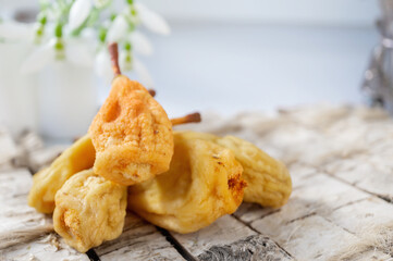 dried whole pears on a light background. pear dried in a dehydrator for preparing food and drinks. pear chips on a light background.