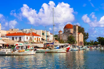 Foto auf Glas Saronics islands of Greece .Authentic beautiful Greek island -Aegina with traditional fishing boats and St. Nicholas Church. © Freesurf