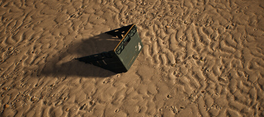 Plastic green crate lying in rippled sand of beach. - 746726068