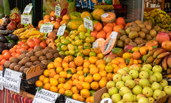Exotic tropical fruit stall at Mercado dos Lavradores, Funchal, Madeira island, Portugal, Europe. Display of local healthy specialities on farmer market. Travel destination for food lovers. Tourism