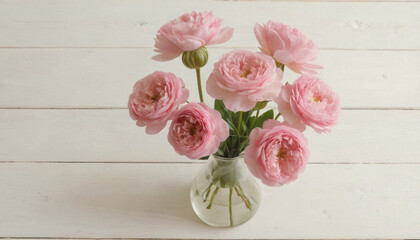 bouquet of pink roses in a vase on white wooden table