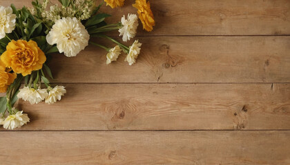 autumn still life with yellow and white flowers on rustic vintage wooden table place for text copyspace