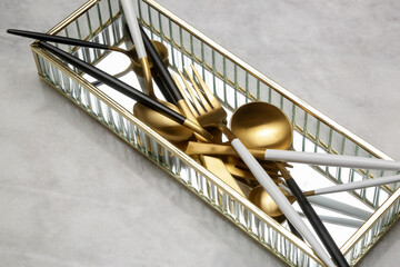 Creative shot of golden cutlery on marble table, Design concept. Modern kitchen. Scandinavian style...