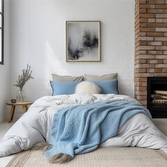 Bed with quilt pillows near fireplace against white brick wall. Loft, modern bedroom interior design
