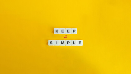 Keep It Simple Phrase. Simplicity as a Guiding Principle
Text on Block Letter Tiles on Yellow...