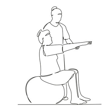 Osteopath giving physical therapy to woman on ball