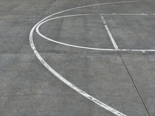 empty urban basketball court with white lines