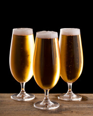 Three Glasses of Beer on a Black Background