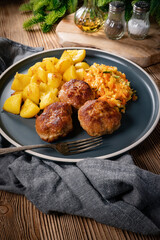 Meatballs  served with fired potatoes.