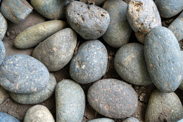 Fototapeta na wymiar Close-up view of smooth pebble stones with varied textures and colors, perfect for natural backgrounds..