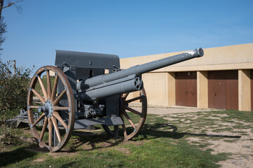Detail of an old military field cannon with wooden spoke carriage wheels at Longues-sur-Mer battery (Batterie de Longues-sur-Mer)