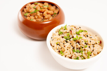Bowl of rice and bean sprinkled with sesame seeds in a white background in aerial view