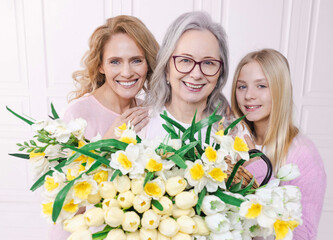Beautiful women of three generations while family meeting. Mother, grandmother and granddaughter...