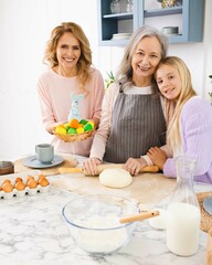 Happy Easter. Women of three generations making Easter cake and holiday dinner in cozy kitchen