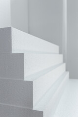 Close up of large panels of Styrofoam are stacked in a warehouse.