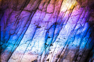 Labradorite iridescence macro photography detail texture. close-up polished semi-precious gemstone.
