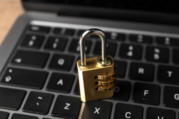 Cyber security. Laptop with padlock on table, closeup
