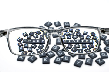 Words short sighted viewed through a pair of glasses for long distance vision