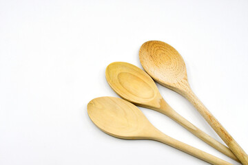 Three wooden sppons isolated on a plain white background. Copy space.