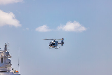 Fototapeta na wymiar Helicopter landing on Mega Yacht anchored in Indian Bay, Saint Vincent and the Grenadines