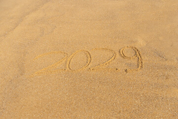 Fototapeta na wymiar 2029 written in the sand on the beach - Happy New Year