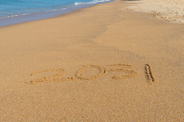 Fototapeta na wymiar 2031 written in the sand on the beach - Happy New Year