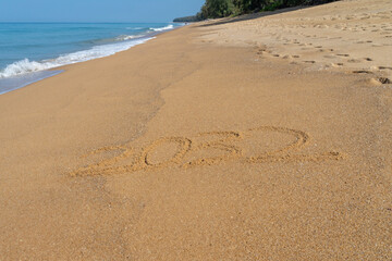 2032 written in the sand on the beach - Happy New Year  