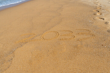 2033 written in the sand on the beach - Happy New Year