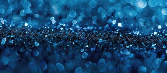 A blue background filled with small lights, creating a mesmerizing bokeh effect. The blue particles add a unique splash of color to the scene, enhancing the overall visual appeal.