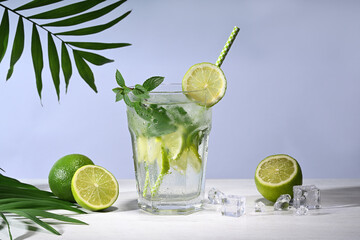 Glass with mojito cocktail and limes - 746784843