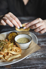 Breaded shrimp and squid rings with cheese sauce. Food photography.