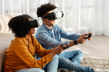 Exhilarated African American couple immersed in a virtual reality game